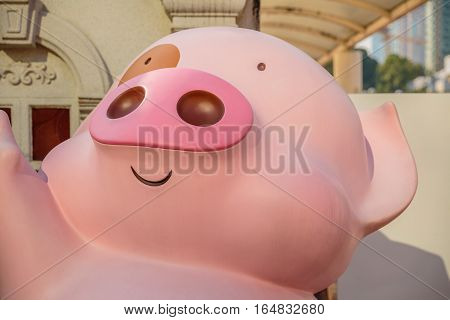 Hong Kong, China - December 5, 2016: McDull close up edition, statues of famous characters, in Hong Kong Avenue of Comic Stars, Kowloon Park. Defocused background of Tsim Sha Tsui District.