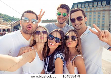 Young Happy Friends Pouting And Gesturing V-sign While Making Selfie