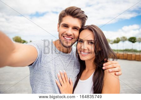 Loving Cheerful Happy Couple Taking Selfie In The City