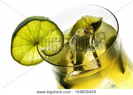 View in a cocktail glass fresh mixed drink with lime and ice alcohol free isolated on a white background selected focus narrow depth of field