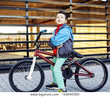 young kid on cool bmx bicycle riding outside, lifestyle people concept close up