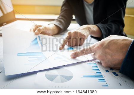 Team work process. young business managers crew working with new startup project. labtop on wood table typing keyboard texting message analyze graph plans.