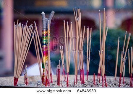 Burning Incense sticks in plublic Temple Thailand