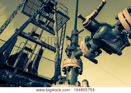 Group of wellhead. Oilfield with sand ground. Oil and gas . Toned.