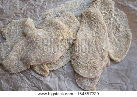 preparing breaded cutlet of veal meat on absorbent paper