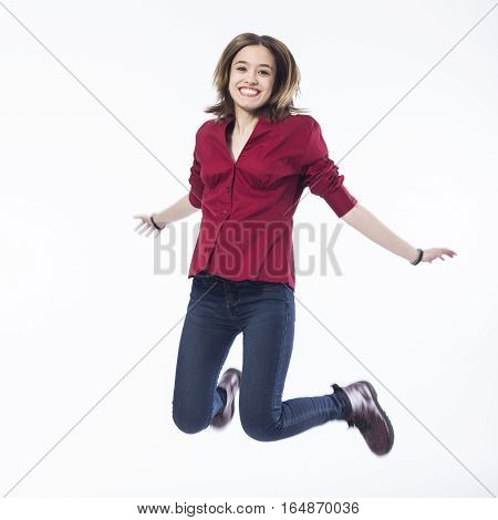 Portrait of happy girl jumping over white background