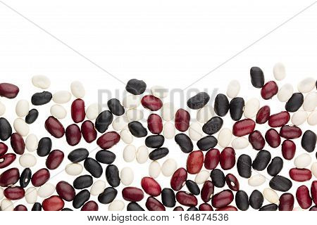 Border of mix black red white kidney beans closeup with copy space on white background. Isolated. Healthy protein food.