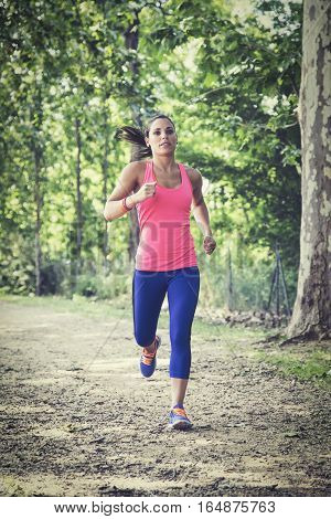 Beautiful woman doing jogging exercises in nature