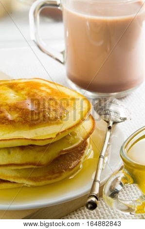 Glass Mug With Cocoa, Silver Spoon, Honey And Pancakes