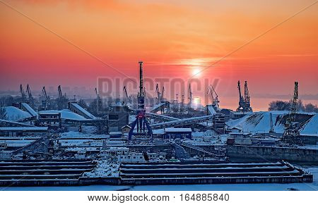 Dockyard winter sunset through the welding glass. Ruse city, Danube river, Bulgaria.
