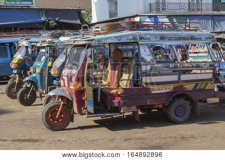 CHAMPASAK LAOS - NOV 23 : three wheel vehicle in pakse market important transportation hub in champasak distric southern of laos on november 23 2013