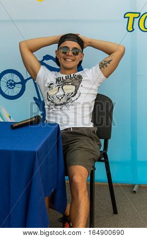 KAZAKHSTAN ALMATY - AUGUST 28, 2016: Urban extreme competition, where the city athletes compete in the disciplines: skateboard, roller skates, BMX. Bmx stunt performed at the top of a mini ramp on a skatepark.