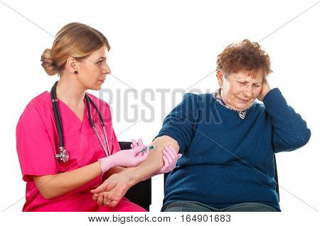Picture of an elderly woman receiving an injection - isolated background