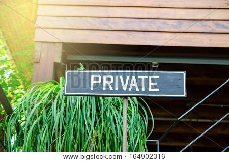 private sign on wood board with sunlight