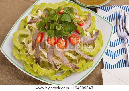 A Thai style dish of raw sea prawn served with cabbage and bitter cucumber and mint in spicy sauce.