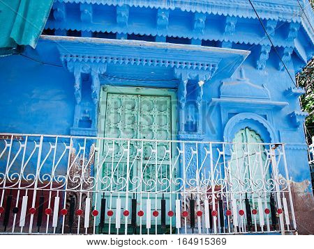 Old wood doors with blue wall. Jodhpur Rajasthan Iindia;