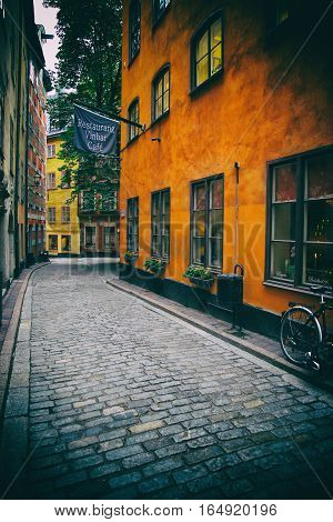 STOCKHOLM SWEDEN - AUGUST 19 2016: View of old narrow Kindstugatan street and colorful buildings in Gamla Stan Gamla Stan is old town in central Stockholm Sweden on August 19 2016.