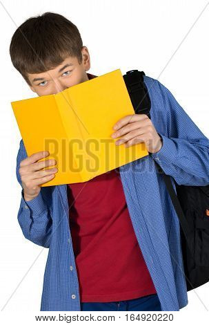 Teen male preppy hiding behind a school book