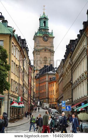 STOCKHOLM SWEDEN - AUGUST 19 2016: View on Church of St. Nicholas (Storkyrkan) and beautiful street Storkyrkobrinken (Gamla Stan) with pedestrian walk in Stockholm Sweden on August 19 2016.