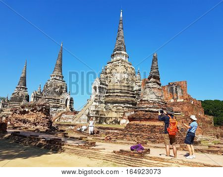 AYUTTHAYA THAILAND - NOVEMBER 29: Unidentified tourists visit Wat Phra Sri Sanphet in the Ayutthaya Historical Park on November 29 2016 in Ayutthaya Thailand