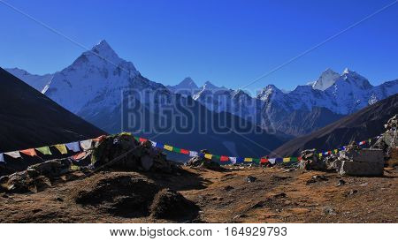 Scene in the Everest National Park Nepal. Majestic mount Ama Dablam. Buddhist prayer flags.