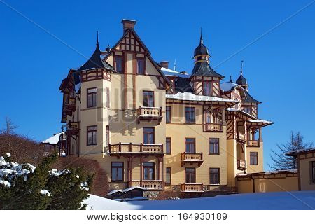 SLOVAKIA STARY SMOKOVEC - JANUARY 06 2015: View of the Grand Hotel in popular resort Stary Smokovec (High Tatras mountains) with half-timbered elements. The hotel was established in 1904.