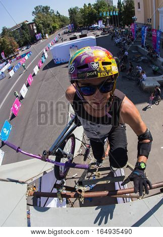 KAZAKHSTAN ALMATY - AUGUST 28, 2016: Urban extreme competition, where the city athletes compete in the disciplines: skateboard, roller skates, BMX. Bmx stunt performed at the top of a mini ramp on a skatepark.