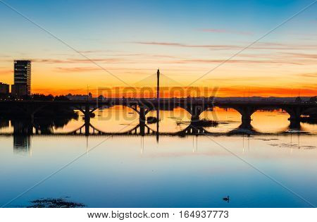 backlighting Real bridge and Guadianas River in sunlate Badajoz Extremadura Spain