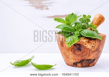 Alternative Medicine Fresh Herbs In The Wooden Mortar . Food Ingredients And Seasoning Basil, Pepper