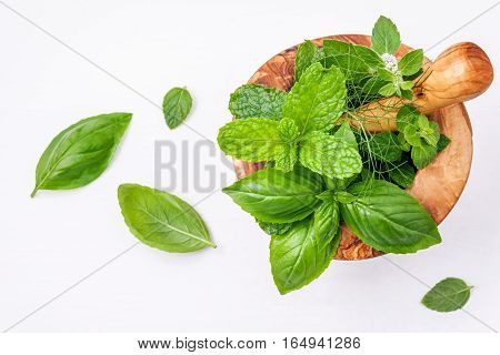 Alternative Medicine Fresh Herbs In The Wooden Mortar . Food Ingredients And Seasoning Basil, Pepper