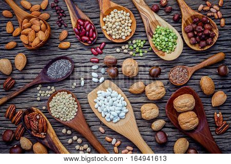 Various Legumes And Different Kinds Of Nutshells In Spoons. Walnuts Kernels ,hazelnuts, Almond ,brow