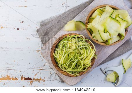 Raw zucchini pasta on white background, copy space