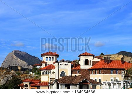 Homes on the hillside on the background of rock