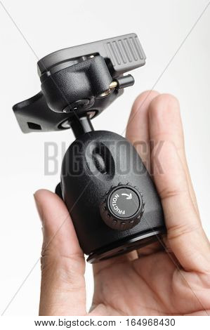 Closeup friction control knob on ball head of tripod