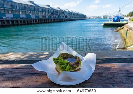 Australian Traditional Meat Pie With Woolloomooloo Bay On The Background