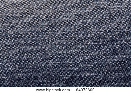 Navy blue shabby denim textile background closeup. Textured fabric macro