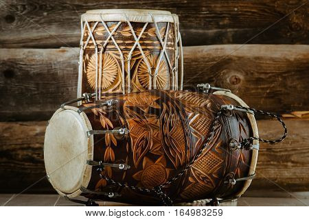 variation of beautiful ethnic indian drums dholak on wooden background
