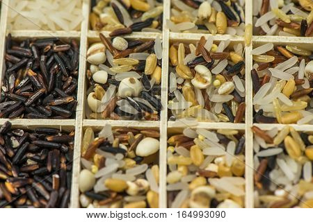 Variety of healthy grains and seeds in a wooden box mostly gluten free with rice, Sensitive Focus