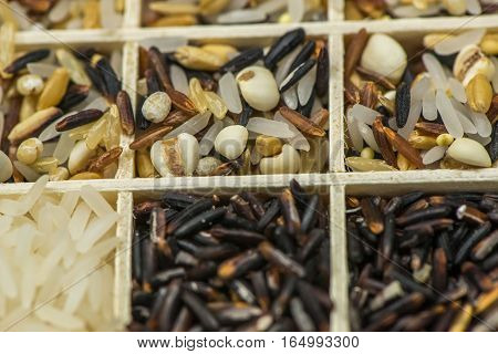 Variety of healthy grains and seeds in a wooden box mostly gluten free with rice, Sensitive Focus