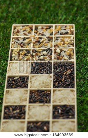 Variety of healthy grains and seeds in a wooden box mostly gluten free with rice, Sensitive Focus