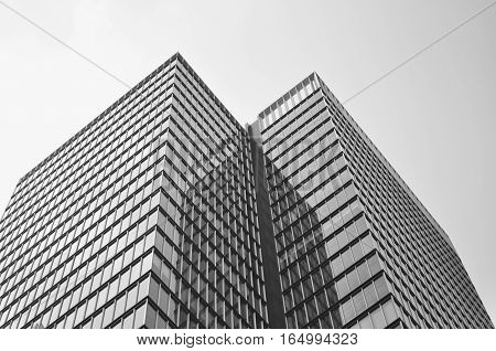 Corner of a glass building against a foggy sky