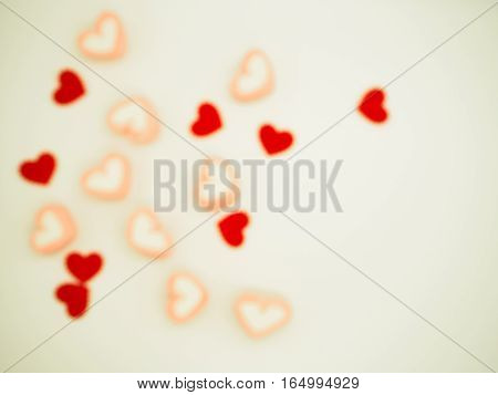 Background of blurred heart shape of marshmallows and heart papers for love St valentine day. Pastal Tone.