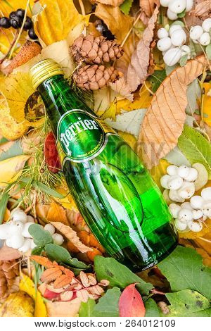 Saint-petersburg, Russia, 17102018 Perrier In A Glass Tin Bottle On Autumn Yellow Green Foliage Of T