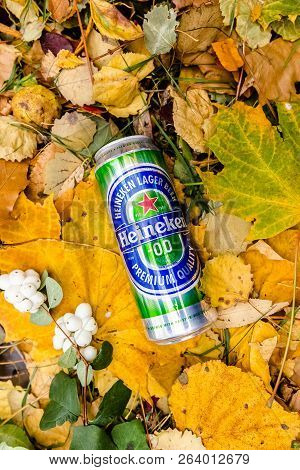 Saint-petersburg, Russia, 17102018 Beer Heineken In A Glass Bottle On Autumn Yellow Green Foliage Of