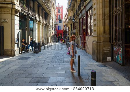 Barcelona, Spain - September 13, 2018: Unknown Woman-tourist With Map And Mobile Phone In Her Hands 