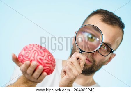 Adult Nerd Man Wearing Eyeglasses Looking At Human Brain Model. Thinking And Intelligence Conept