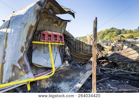 Damaged Industry Supermarket Metallic Facade After Arson Fire With Burnt Debris After Intense Burnin