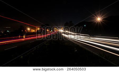 Fast Driving Vehicles Trial At Night, With Long Exposure Blurred Effect At Indian Nation Highway 19 