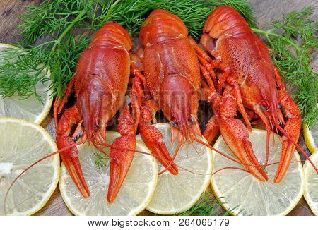 Crayfish And Lemons On A Wooden Table
