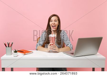 Crazy Funny Woman Making Faces Showing Tongue Squinting Eyes Holding Plactic Cup With Cola Soda Work